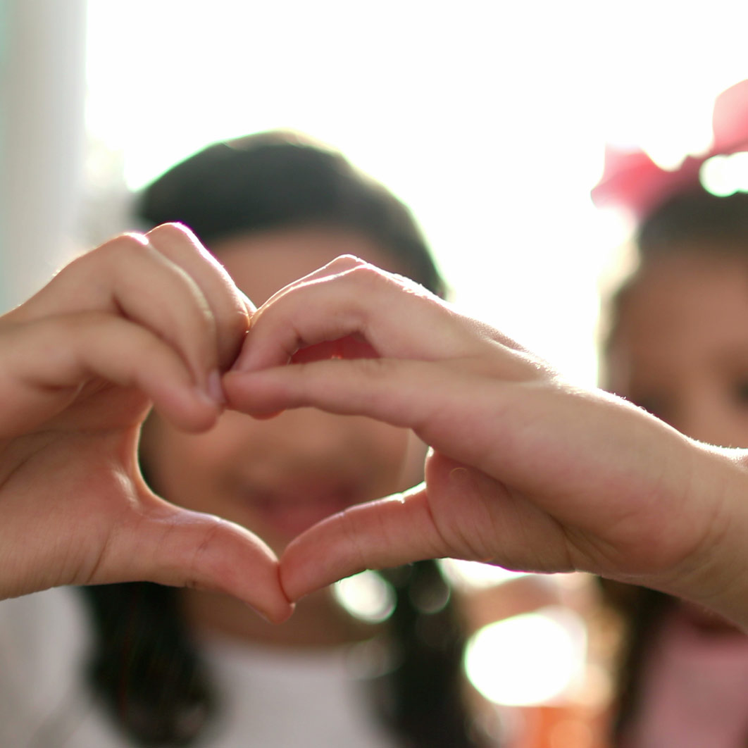 Two hands held together to form the shape of a heart