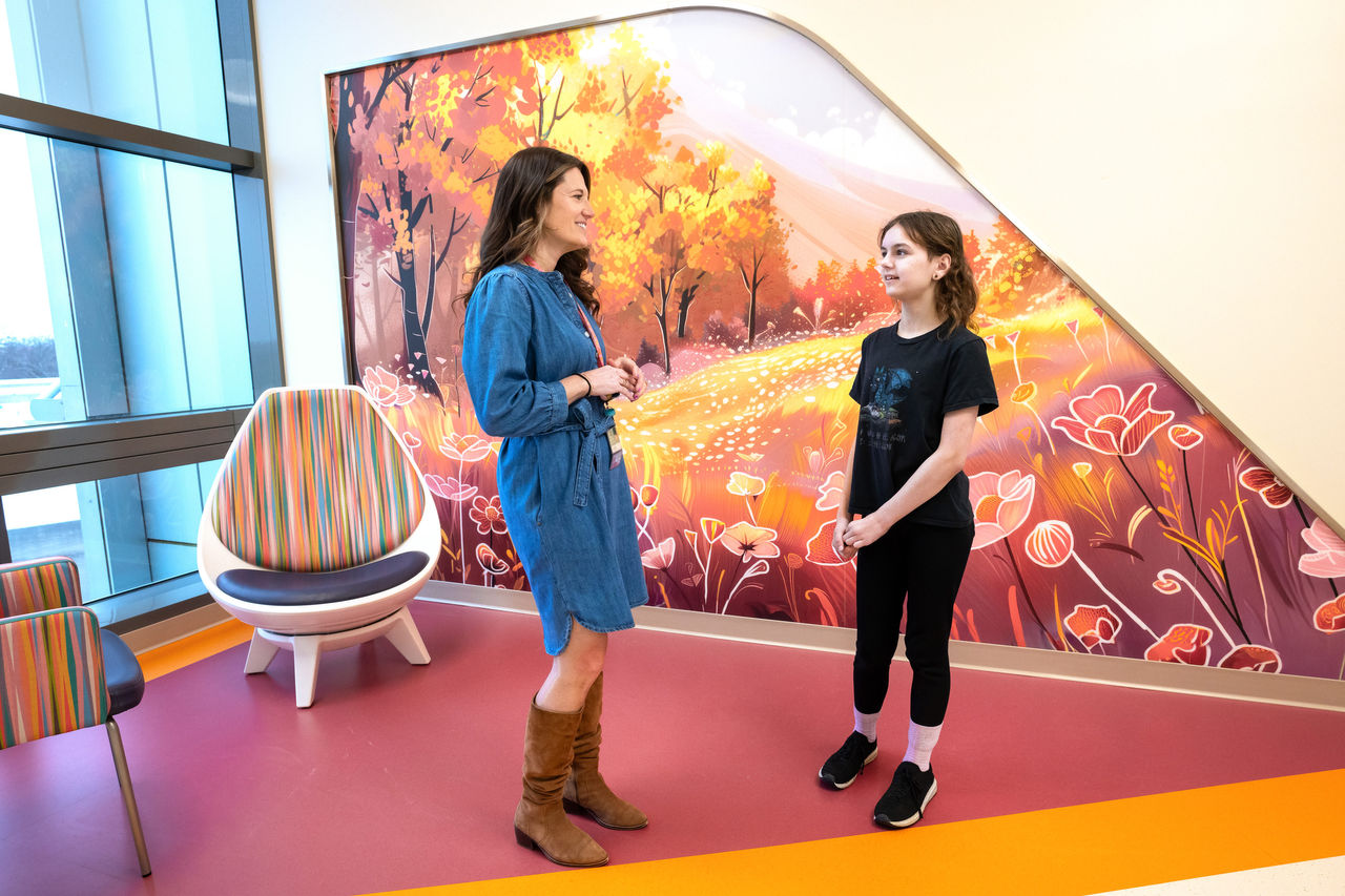 Two people talking in a bright and vibrant waiting area