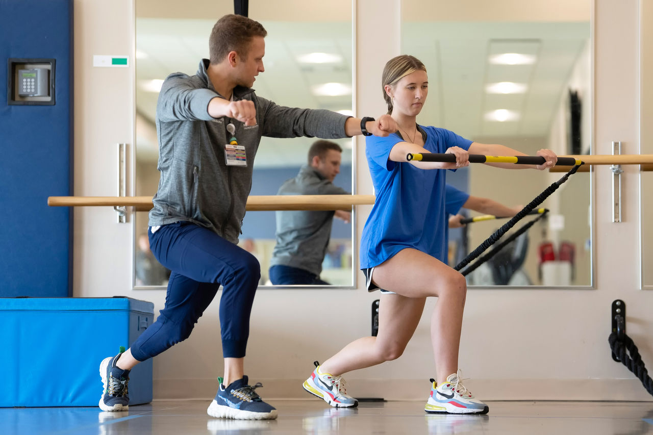 Teen girl lunging in physical therapy