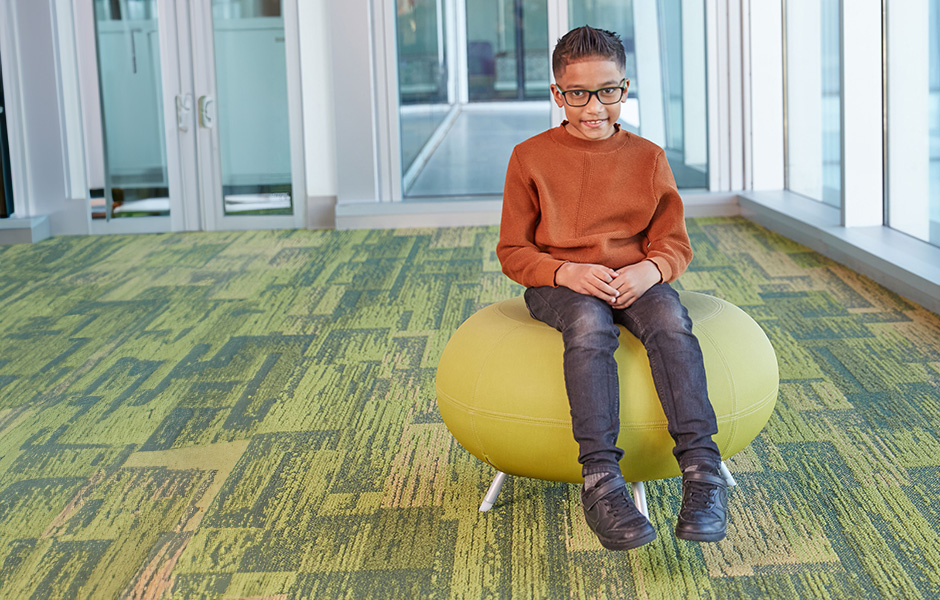 22q patient. Boy sitting on a stool
