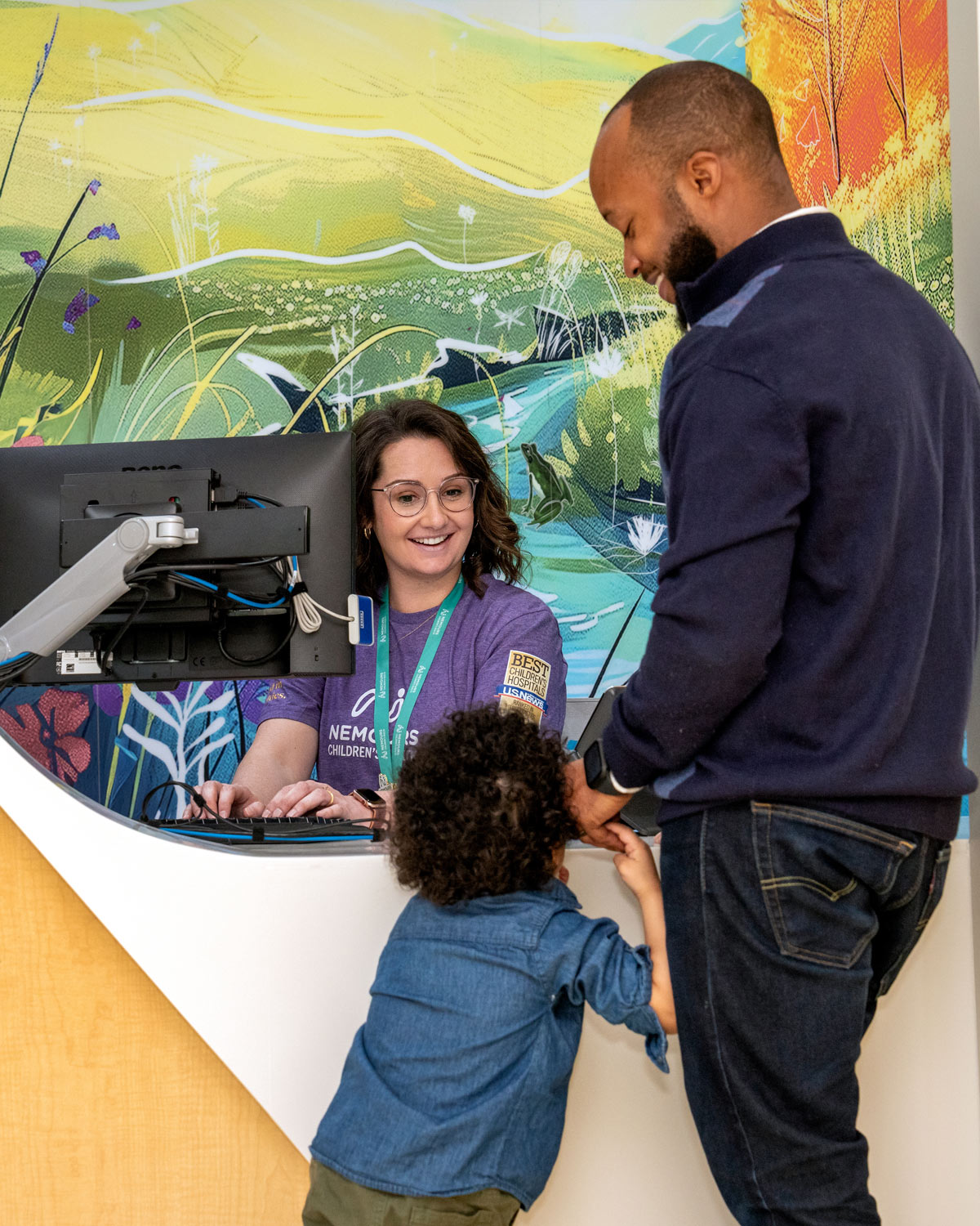 Father and son checking in at the front desk