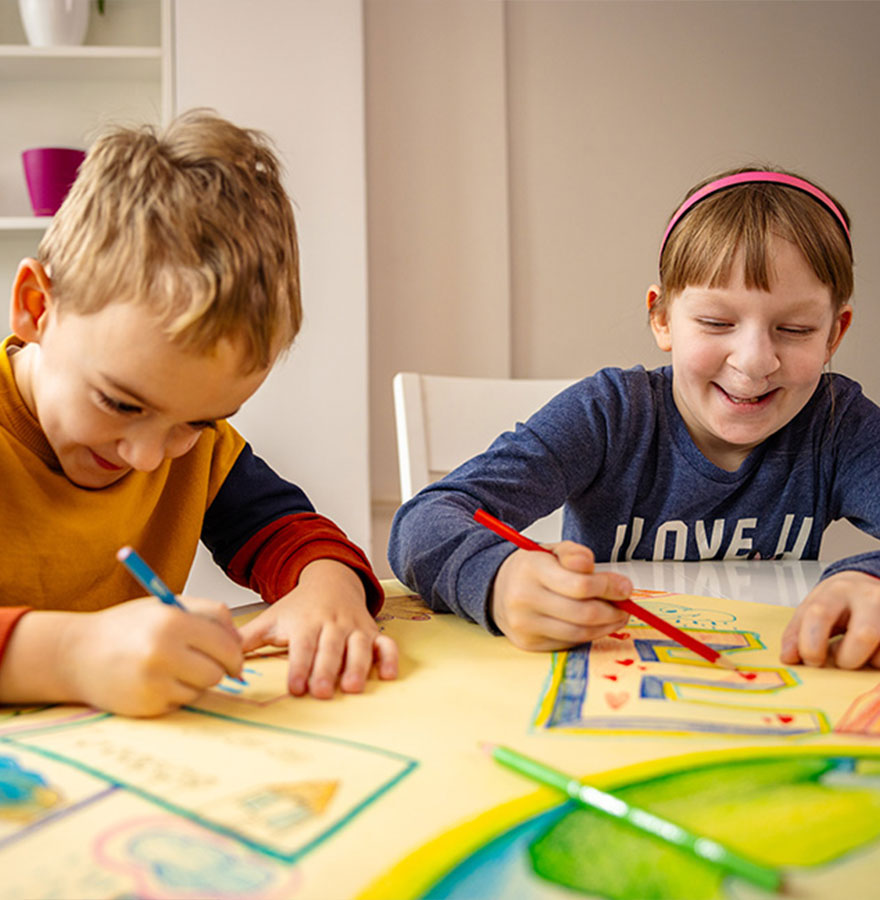Girls with cleft lip coloring with friend