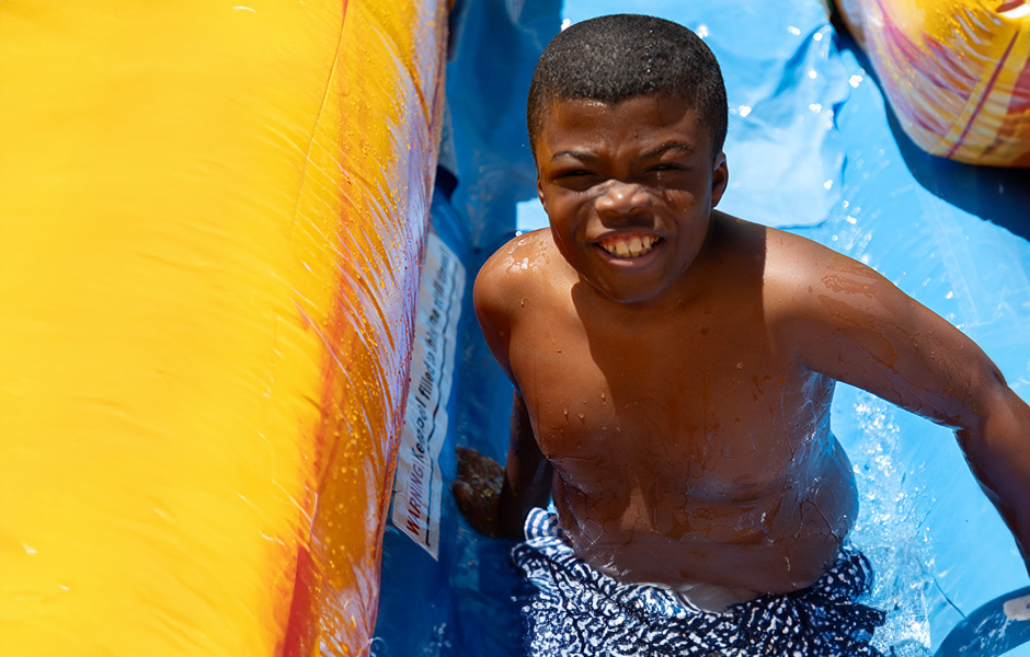 22q patient. Boy on a water slide.