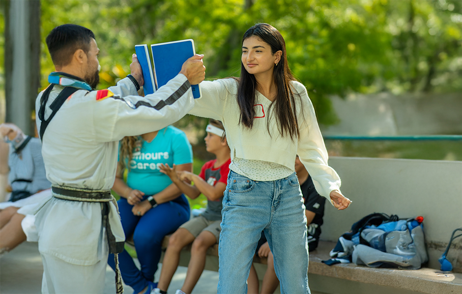 Cochlear implant summer camp teen with a karate instructor