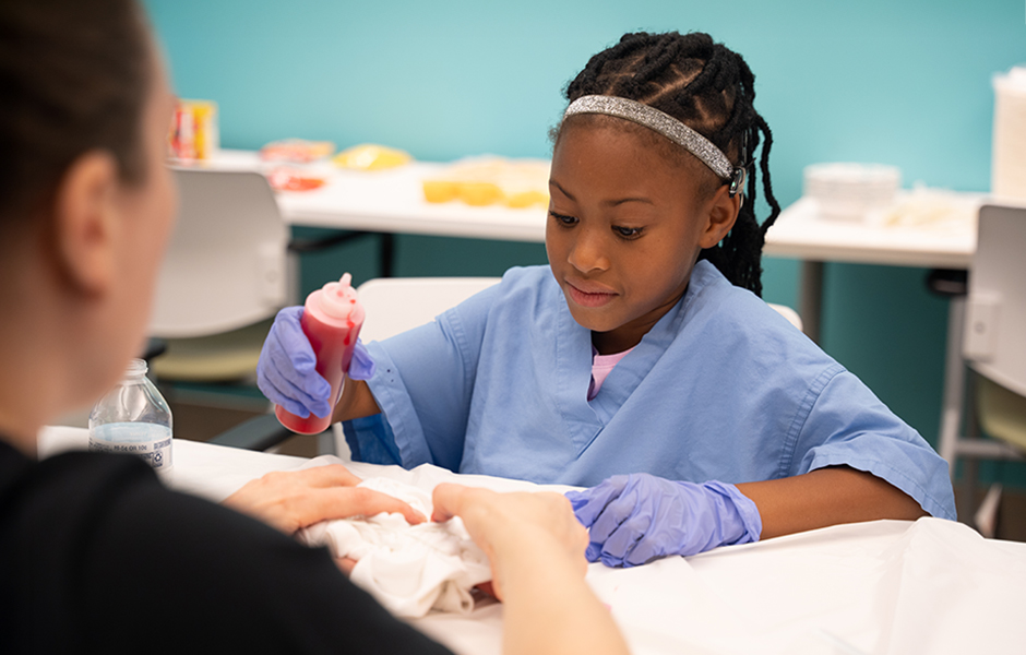 Cochlear implant summer camp child with an instructor