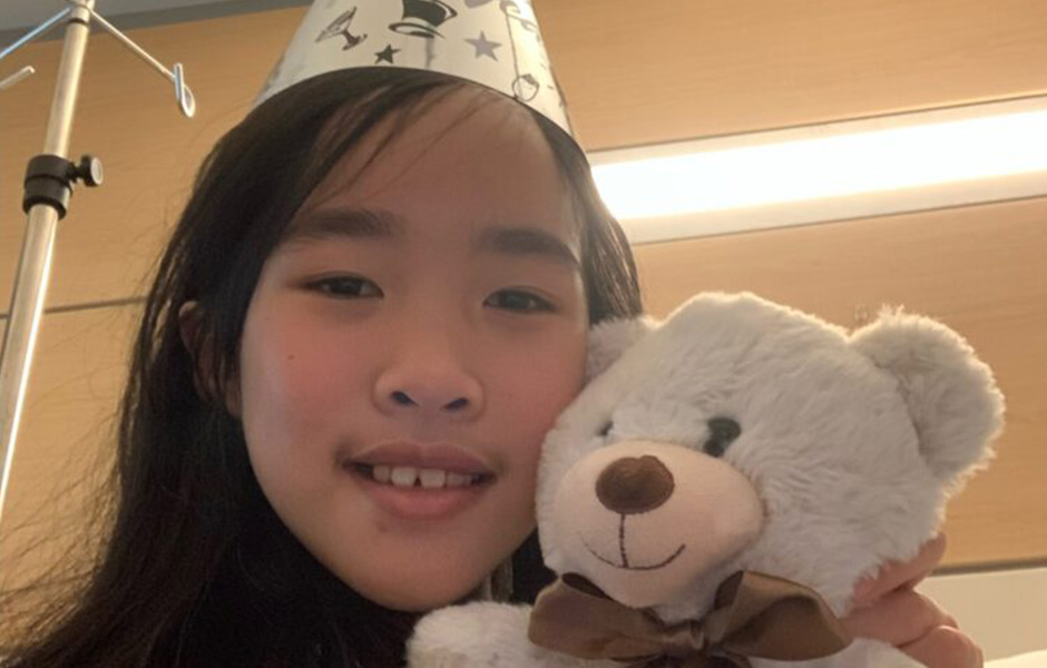 Jessica, a lymphoma patient, holding a teddy bear.